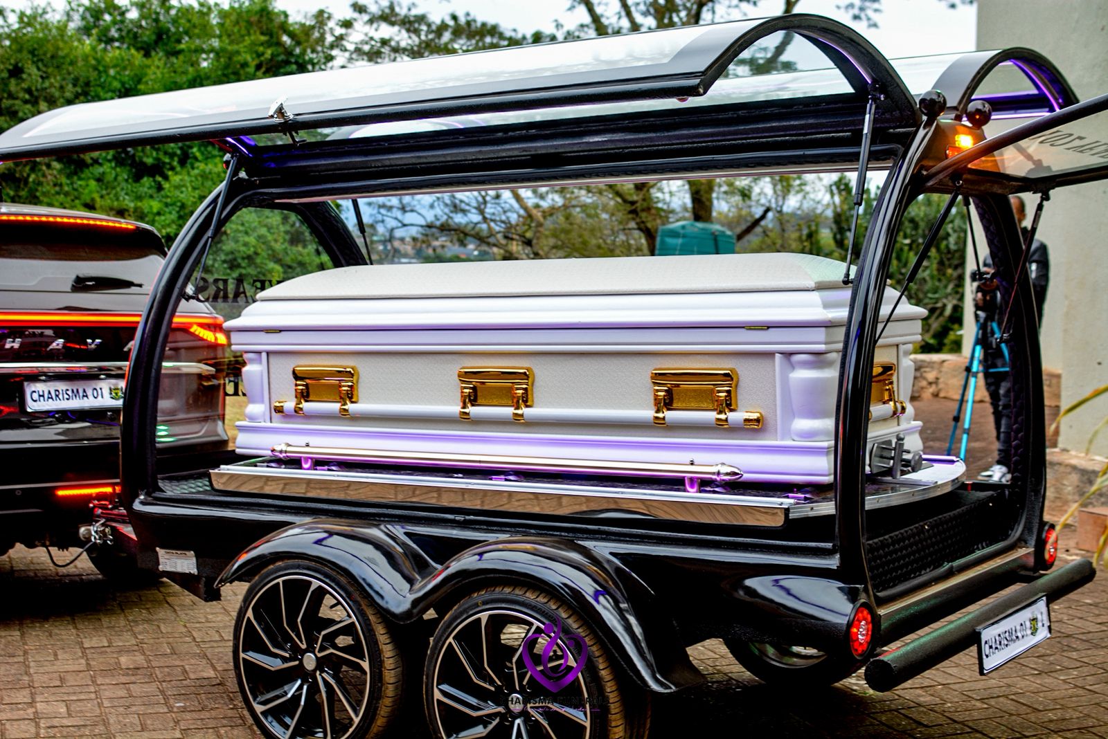 White casket in glass hearse carriage